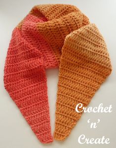 two crocheted scarfs sitting next to each other