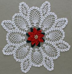 a crocheted doily with a poinsetti on it