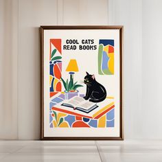 a black cat sitting on top of an open book in front of a wall mounted poster