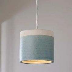 a blue and white lamp hanging from a ceiling