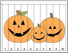 two pumpkins with faces cut out on a ruler