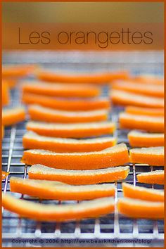 oranges are being cooked on a grill with the words les orangettes above them