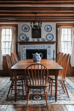 the dining room table is surrounded by blue and white plates on the fireplace mantel