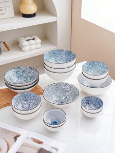 a white table topped with blue and white dishes