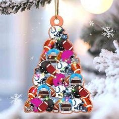 an ornament shaped like a christmas tree with footballs and helmets on it