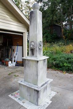 a cement sculpture in front of a garage