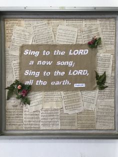 a framed piece of paper with words and flowers on it that reads, sing to the lord a new song, sing to the lord, all the earth