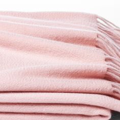 pink blanket folded on top of each other