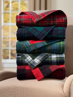 a stack of blankets sitting on top of a chair