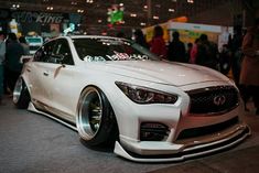 a white car parked on top of a show floor