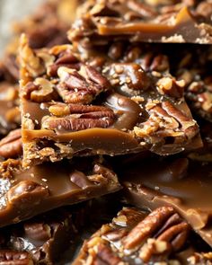 chocolate and pecans are stacked on top of each other with caramel in the middle