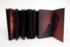 an open book with the image of a woman's face on it, in front of a white background