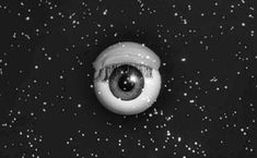 an eyeball is shown in the middle of a black and white photo with snow all around it