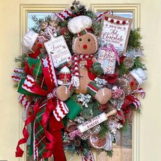 a christmas wreath with gingerbreads, candy canes and other holiday decorations hanging on the front door