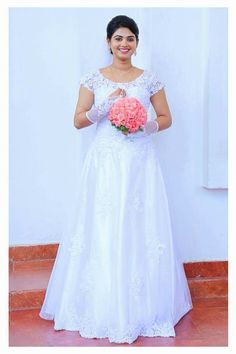 a woman in a wedding dress holding a bouquet