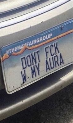 there is a car license plate that says don't f k my aura