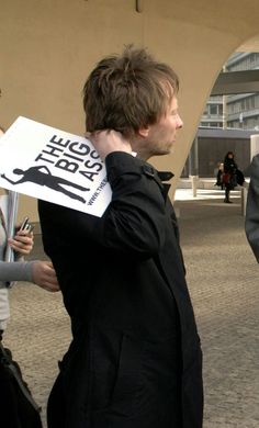 a man holding a sign in his hand