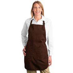 a woman wearing an apron and smiling at the camera with her hands on her hips