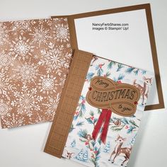 two christmas cards are sitting next to each other