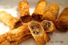 some fried food items are on a white plate and is ready to be eaten or eaten