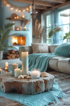 candles are placed on a piece of driftwood in front of a living room fire place