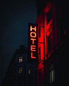 the hotel sign is lit up at night