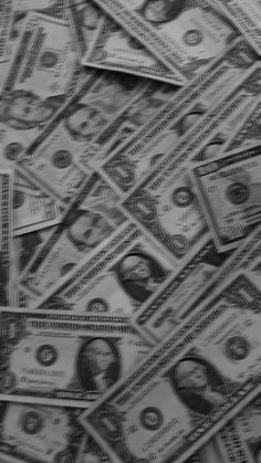 black and white photograph of many hundred dollar bills