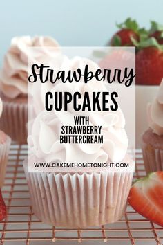 strawberry cupcakes on a cooling rack with strawberries