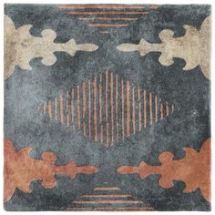 a rug with an abstract design on the floor in grey, orange and brown colors