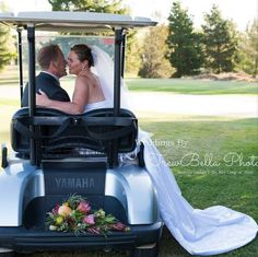 a bride and groom in a golf cart