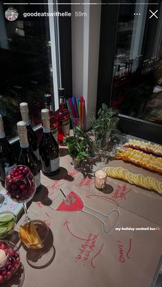 a table topped with lots of bottles of wine next to fruit and veggies