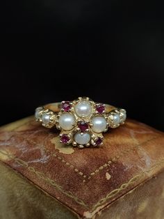 This beautiful vintage ring dates to circa 1970s featuring a statement cluster of natural pearl and ruby gemstones set in a decoratively fashioned 14ct yellow gold mount hallmarked for London.  UK size - O US size - 7 Weight approx - 3.1 grams Message me any questions Engagement Pearl Ring, Pearl And Ruby Ring, Non Traditional Engagement Rings Vintage, Pearl Engagement Ring Vintage, 1970s London, Ruby Jewelry Ring, Diamond Earrings Indian, Pearl Rings Vintage, Beautiful Rings Vintage