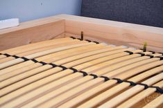 a close up of a bed with wooden slats