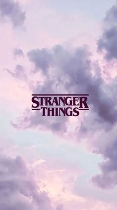 the words strange things are written in front of some clouds with purple and blue colors