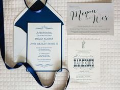 the wedding stationery is laid out on top of each other, including a blue ribbon