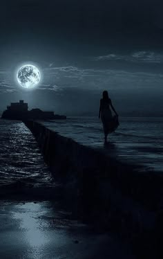 a woman is walking on the edge of a pier at night with the moon in the background