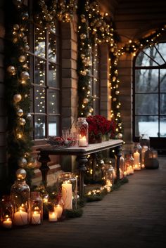 lighted candles are lined up along the side of a building in front of large windows