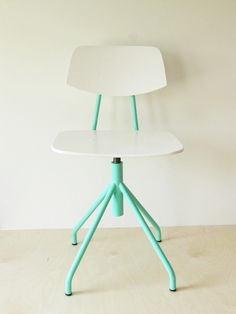 a white and blue chair sitting on top of a wooden floor