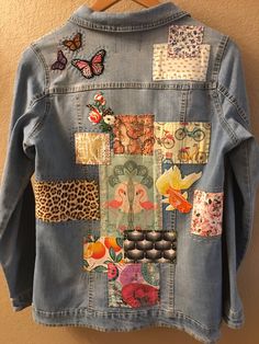 a denim jacket with patches and flowers on it