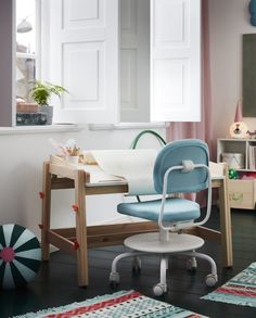 a blue chair sitting on top of a wooden desk