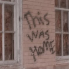 graffiti on the side of a brick building that says this was youth written in black