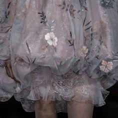 the back of a woman's dress with flowers on it