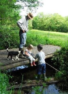 a man and two children playing on a bridge