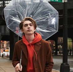 a man holding an umbrella on the street