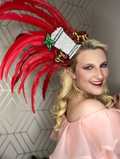 Don't just fit in, stand out this Kentucky Derby season with this unique handcrafted headpiece featuring bright red large feathers, topped off with a sparkly Mint Julep, red glittered roses, and metallic gold horses. This headpiece makes for the perfect accessory to complete your outfit!! Red Tall Crown Costume Hat For Party, Red Mini Hats With Feather Trim For Party, Red Carnival Party Costume Hats And Headpieces, Festive Red Headband, Red Carnival Costume Hats And Headpieces For Party, Red Costume Accessories For Carnival, Red Christmas Party Headpiece, Red Mini Hats For Carnival Party, Red Headband For Carnival Party