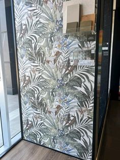 a glass door that has some plants on it