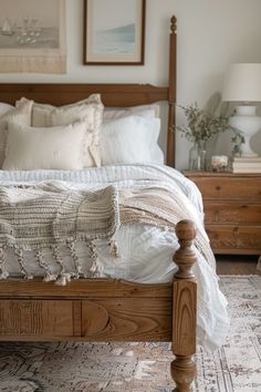 a bed with white linens and pillows in a bedroom