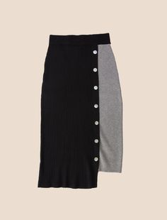 Whether worn for a romantic soirée, a lively happy hour, or a leisurely stroll along the beach, this high-waisted skirt will flow wherever you go. The variation in hem length adds movement and creates drama while an off-center line of decorative buttons add textural play. For a total coordinated ensemble, pair it with our Xyla Top, Sapo Top or Gitana Cardi. TWO-TONE PENCIL SKIRT IN MULTI-RIB PATTERN AND ACCENT MOP BUTTONS AT TIERED BELOW KNEE LENGTH Ray is 5'11” wearing a size S/M Available size Chic Black Asymmetrical Skirt, Elegant Black Maxi Skirt For Day Out, Black Pleated Maxi Skirt For Day Out, Black Asymmetrical Relaxed Skirt, Chic Black Asymmetrical Maxi Skirt, Black Asymmetrical Skirt For Day Out, Chic Black Midi Skirt, Mop Buttons, Center Line