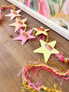 some paper stars are laying on the floor next to other crafting supplies and decorations