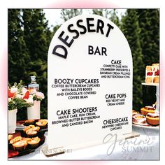 dessert bar sign displayed on table with pastries and cakes for sale at outdoor event